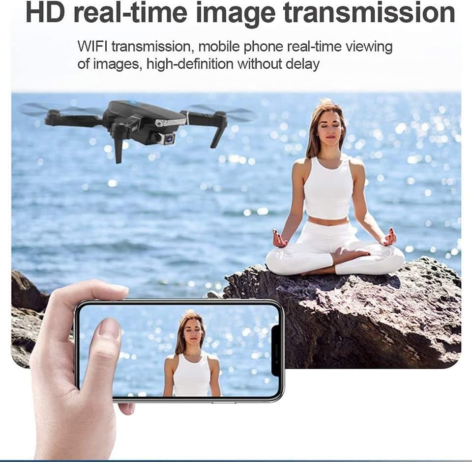 Drone capturing HD real-time video of woman meditating by the sea, viewed on smartphone, Tafeen Toys