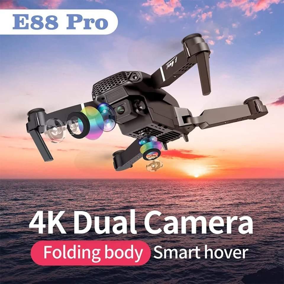 E88 Pro foldable drone with 4K dual camera flying above ocean at sunset, Tafeen Toys