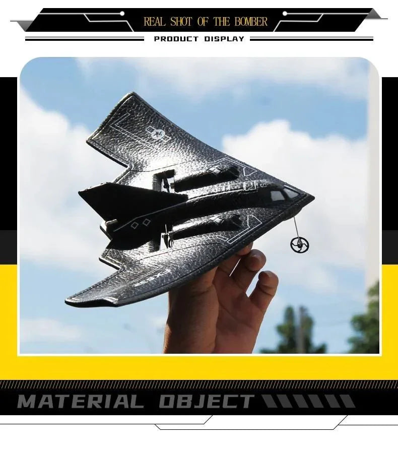 Hand holding black toy stealth bomber airplane outdoors, Tafeen Toys product display.